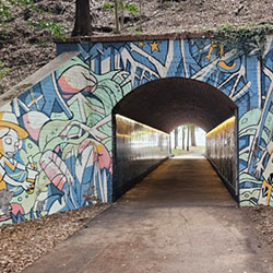 Walking tunnel with a wildly colorful entryway painted by an artist